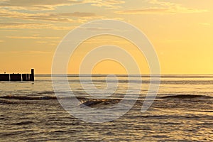 Sunset at the baltic sea beach of ustronie morskie, poland