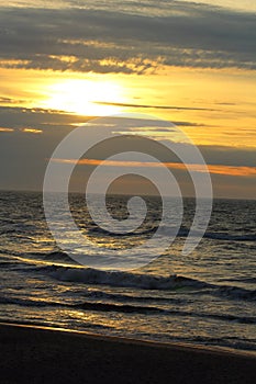 Sunset at the baltic sea beach of ustronie morskie, poland