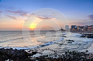 Sunset at Barra Beach with Farol da Barra Barra Lightouse on Background - Salvador, Bahia, Brazil photo