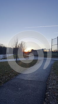 sunset baseball field in a park at dusk dawn