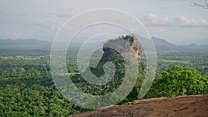 Sunset bathes Sigiriya Rock in warm light, ancient fortress atop iconic Lion Rock rises above Sri Lankan jungle