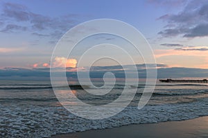 Sunset on the beach with the Apache Pier in the background.