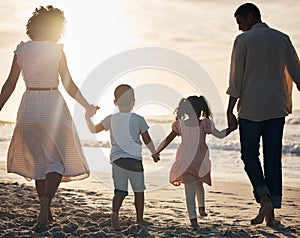 Sunset, beach and back of family holding hands in nature for travel, bond and fun together. Rear view, love and children