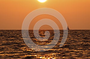 Sunset Beach Background. waves of the sea in the rays of the evening sunset. the sun goes below the horizon