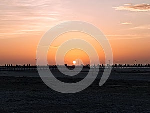 Sunset on the beach, in beautiful blues and orange.