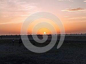 Sunset on the beach, in beautiful blues and orange.