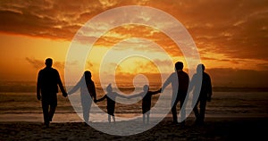 Sunset, beach and big family holding hands at the ocean with love, trust and freedom on sky background. Sunrise, travel