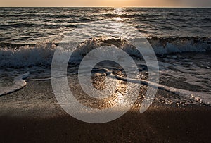 Sunset on the beach with black sand.