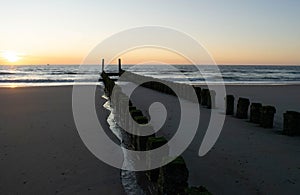 Sunset at the beach, blue hour, breakwaters