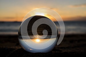 Sunset on Beach Captured Through Glass Ball