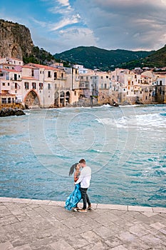 Sunset at the beach of Cefalu Sicily, old town of Cefalu Sicilia panoramic view at the colorful village