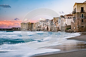Sunset at the beach of Cefalu Sicily, old town of Cefalu Sicilia panoramic view at the colorful village