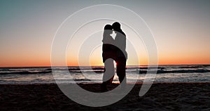 Sunset, beach and couple with silhouette, hug and love with vacation, anniversary and romance. Seaside holiday, man or