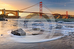 Sunset at the beach by the Golden Gate Bridge in San Francisco C