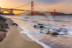 Sunset at the beach by the Golden Gate Bridge in San Francisco C