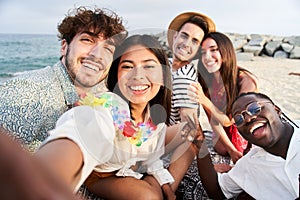 Sunset beach - Group of five cheerful young friends taking selfie portrait. Happy people looking at the camera