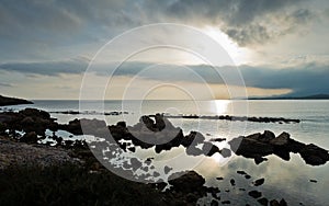 Sunset on a beach at Nora archeological site, near city of Pula, island of Sardinia