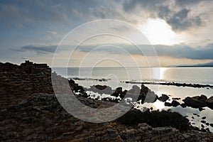 Sunset on a beach at Nora archeological site, near city of Pula, island of Sardinia