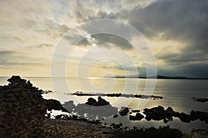 Sunset on a beach at Nora archeological site, near city of Pula, island of Sardinia