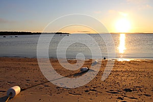 Sunset from the beach over the water