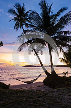 sunset on the beach with palm tree and hammock, Koh Mak Island Thailand