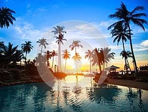 Sunset at a beach resort in tropics.