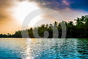 Sunset at a beach resort in the tropics.