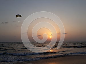 sunset on the beach, wave on the beach, beautiful sunset view in the Indian Ocean, sunset view in the goa,