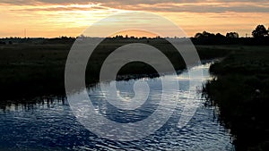 Sunset: beautiful blue water, orange sky