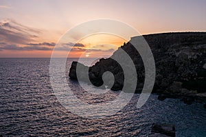 Sunset on a beautiful spring day with calm sea, seen from Anchor Bay, Mellieha, Malta.