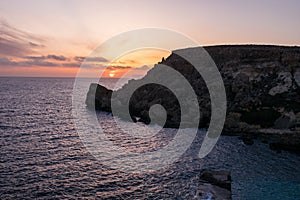 Sunset on a beautiful spring day with calm sea, seen from Anchor Bay, Mellieha, Malta.