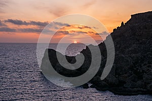 Sunset on a beautiful spring day with calm sea, seen from Anchor Bay, Mellieha, Malta.