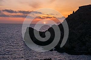 Sunset on a beautiful spring day with calm sea, seen from Anchor Bay, Mellieha, Malta.