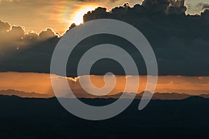 Sunset behind big dim cloud