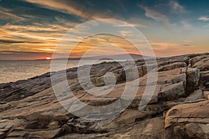 Sunset behind Cadillac Mountain Acadia National Park as seen from Schoodic Point