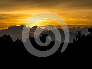 Sunset behind cloud and mountain