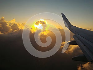 sunset behind clouds from airplane