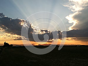 Sunset behind clouds over mountains