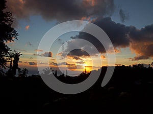 Sunset behind the clouds over the ocean on Tantalus mountain