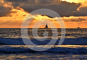 Sunset behind clouds over Pacific Ocean