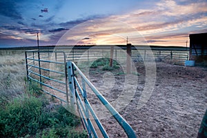 Sunset behind fencing and barn in Eastern Plains Colorado