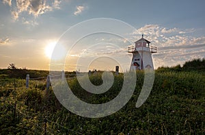 Sunset behind lighthouse on the beach on Prince Edward Island