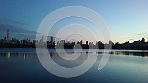 Sunset behind Midtown and Upper West Side Buildings Seen from Central Park in Manhattan, New York, NY.