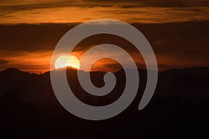 Sunset behind mountain and cloud