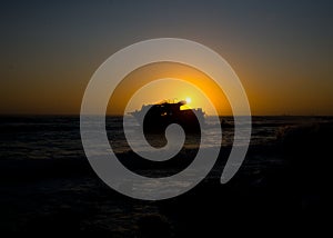 Sunset behind shipwreck near cape agulhas