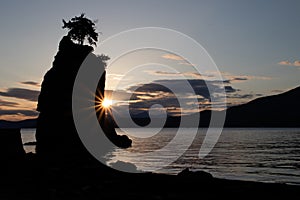 Sunset behind Siwash rock in Stanley park Vancouver Canada photo