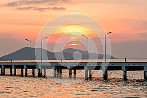 Sunset behind Small port ship and lamp post