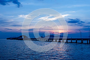 Sunset behind Small port ship and lamp post