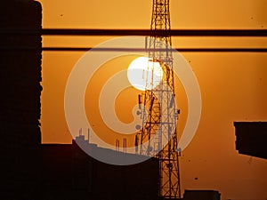 Sunset behind tower at evening