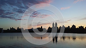 Sunset behind Upper West Side Buildings Seen from Jacqueline Kennedy Onassis Reservoir in Central Park in Manhattan, New York, NY.